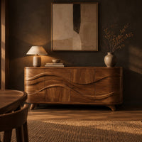 Wave carved sideboard with four front panels and short tapered feet in a dark dining room at golden hour