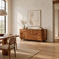 Wave carved sideboard with four front panels and short tapered feet in a bright open plan dining room