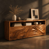 Low sideboard with three carved wave panels and an open display shelf above, three-quarter view showing the grain