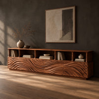 Low tv stand with wave carved front panels and a row of open cubbies, three-quarter view showing the grain