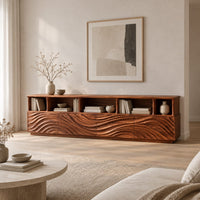 Low tv stand with wave carved front panels and a row of open cubbies in a Scandinavian living room with white walls