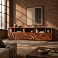 Low tv stand with wave carved front panels and a row of open cubbies in an industrial loft living room with exposed brick