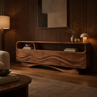 Tv stand with wave carved panels, an open top shelf and an arched base in an evening living room with walnut wall paneling