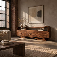 Tv stand with wave carved panels, an open top shelf and an arched base in an industrial loft living room with exposed brick