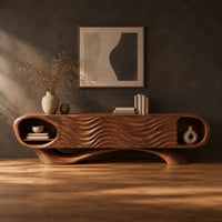 Wooden tv stand with oval end niches, wave carved panels and a swept base in a dark studio against a charcoal plaster wall