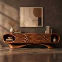 Corner detail of wooden tv stand with oval end niches, wave carved panels and a swept base beside wood, brass and linen samples