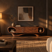 Wooden tv stand with oval end niches, wave carved panels and a swept base in a dark living room at golden hour