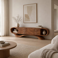 Wooden tv stand with oval end niches, wave carved panels and a swept base in a Scandinavian living room with white walls
