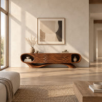 Wooden tv stand with oval end niches, wave carved panels and a swept base in a bright open plan living room