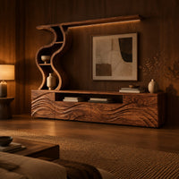 Long wood media cabinet with wave carved fronts and an s shaped shelf tower in an evening living room with walnut wall paneling