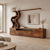 Long wood media cabinet with wave carved fronts and an s shaped shelf tower in a Scandinavian living room with white walls
