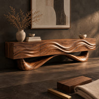 Corner detail of tv stand with a wave carved cabinet on a sweeping sculpted base beside wood, brass and linen samples