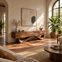 Tv stand with a wave carved cabinet on a sweeping sculpted base in a bright living room with arched windows and plants