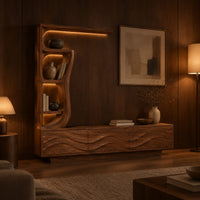 Low wave carved cabinet with a tall open shelf tower and a top shelf in an evening living room with walnut wall paneling