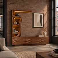 Low wave carved cabinet with a tall open shelf tower and a top shelf in an industrial loft living room with exposed brick