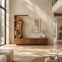 Low wave carved cabinet with a tall open shelf tower and a top shelf in a bright open plan living room