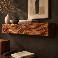 Corner detail of thick wood mantel beam with deep wave carved ridges across the front beside wood, brass and linen samples