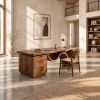 Desk with a thick slab top, three drawer pedestal and a wave shaped leg in a bright open plan home office