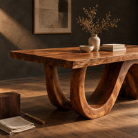 Corner detail of dining table with a live edge top and a looping wave base beside wood, brass and linen samples
