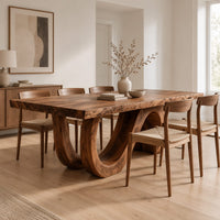 Dining table with a live edge top and a looping wave base in a Scandinavian dining room with white walls