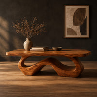 Rectangle coffee table with softly shaped corners on a flowing wave loop base in a dark studio against a charcoal plaster wall