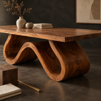 Corner detail of long dining table on a single sculpted wave ribbon base beside wood, brass and linen samples