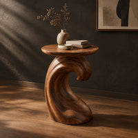 Side table with a wave shaped pedestal and a circular top, three-quarter view showing the grain