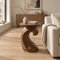 Side table with a wave shaped pedestal and a circular top in a Scandinavian living room with white walls