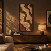 Wall art panel with flowing two tone wave relief in a slim frame above a low console in an evening living room