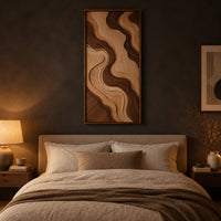 Wall art panel with flowing two tone wave relief in a slim frame above a bed in a dusk lit bedroom
