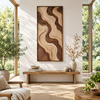 Wall art panel with flowing two tone wave relief in a slim frame in a bright sunroom with green plants