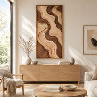 Wall art panel with flowing two tone wave relief in a slim frame above a light oak sideboard in daylight