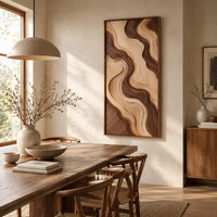 Wall art panel with flowing two tone wave relief in a slim frame beside a dining table in natural light