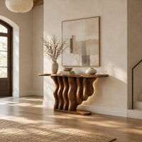 Console table with a base of wavy wood columns on an oval foot in a bright open plan entryway