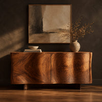Wavy edged sideboard with two front panels and bold wood grain in a dark studio against a charcoal plaster wall