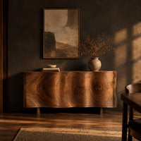 Wavy edged sideboard with two front panels and bold wood grain in a dark dining room at golden hour