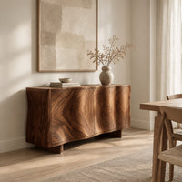 Wavy edged sideboard with two front panels and bold wood grain in a Scandinavian dining room with white walls
