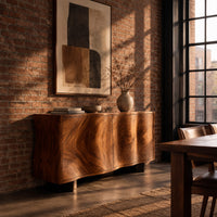 Wavy edged sideboard with two front panels and bold wood grain in an industrial loft dining room with exposed brick