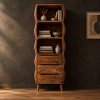 Tall bathroom cabinet with three wavy open shelves and three drawers in a dark studio against a charcoal plaster wall
