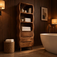 Tall bathroom cabinet with three wavy open shelves and three drawers in an evening bathroom with walnut wall paneling