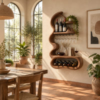 Wavy frame wine rack with a stemware rail and an oval bay in a bright dining room with arched windows and plants