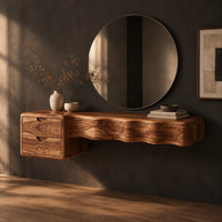 Floating wood makeup vanity with a wavy carved front and two small drawers, three-quarter view showing the grain