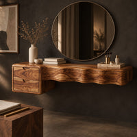 Corner detail of floating wood makeup vanity with a wavy carved front and two small drawers beside wood, brass and linen samples