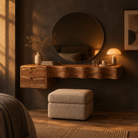 Floating wood makeup vanity with a wavy carved front and two small drawers in a dark bedroom at golden hour