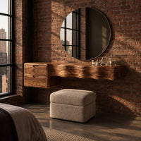 Floating wood makeup vanity with a wavy carved front and two small drawers in an industrial loft bedroom with exposed brick