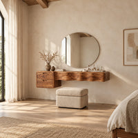 Floating wood makeup vanity with a wavy carved front and two small drawers in a bright open plan bedroom