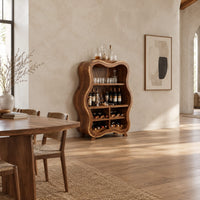 Tall wavy outline bar cabinet with open shelves and four wine cubbies in a bright open plan dining room