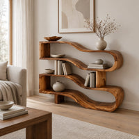 Wavy ribbon bookshelf with open shelves joined by chunky square posts in a Scandinavian living room with white walls