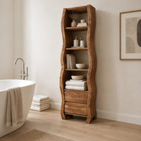 Tall narrow cabinet with wavy sides, four open shelves and two drawer fronts below in a Scandinavian bathroom with white walls