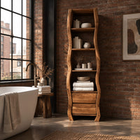 Tall narrow cabinet with wavy sides, four open shelves and two drawer fronts below in an industrial loft bathroom with exposed brick